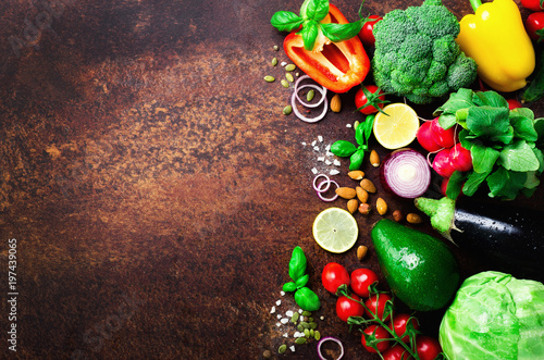 Set of fresh vegetables on brown background. Aromatic herbs, onion, avocado, broccoli, pepper bell, eggplant, cabbage, radish, cucumber, almonds, rucola, baby corn. Banner