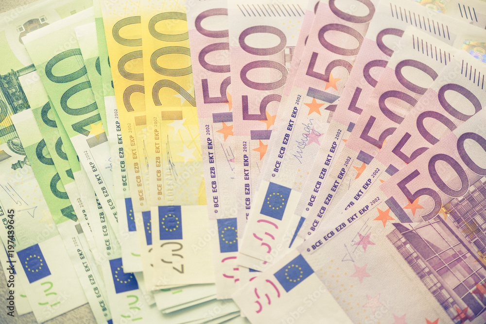 Euro currency money banknotes background. Payment and cash concept. Announced cancellation of five hundred euro banknotes. Top view. Toned image Euro currency money banknotes background. Payment and cash concept. Announced cancellation of five hundred euro banknotes. Top view. Toned image
