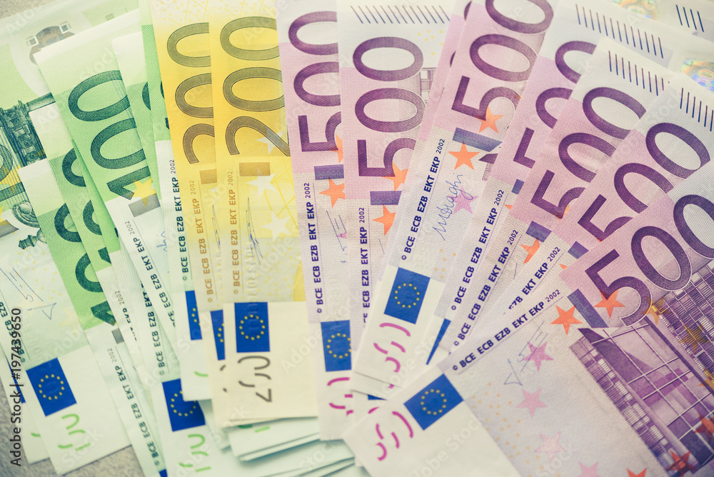 Euro currency money banknotes background. Payment and cash concept. Announced cancellation of five hundred euro banknotes. Top view. Toned image Euro currency money banknotes background. Payment and cash concept. Announced cancellation of five hundred euro banknotes. Top view. Toned image