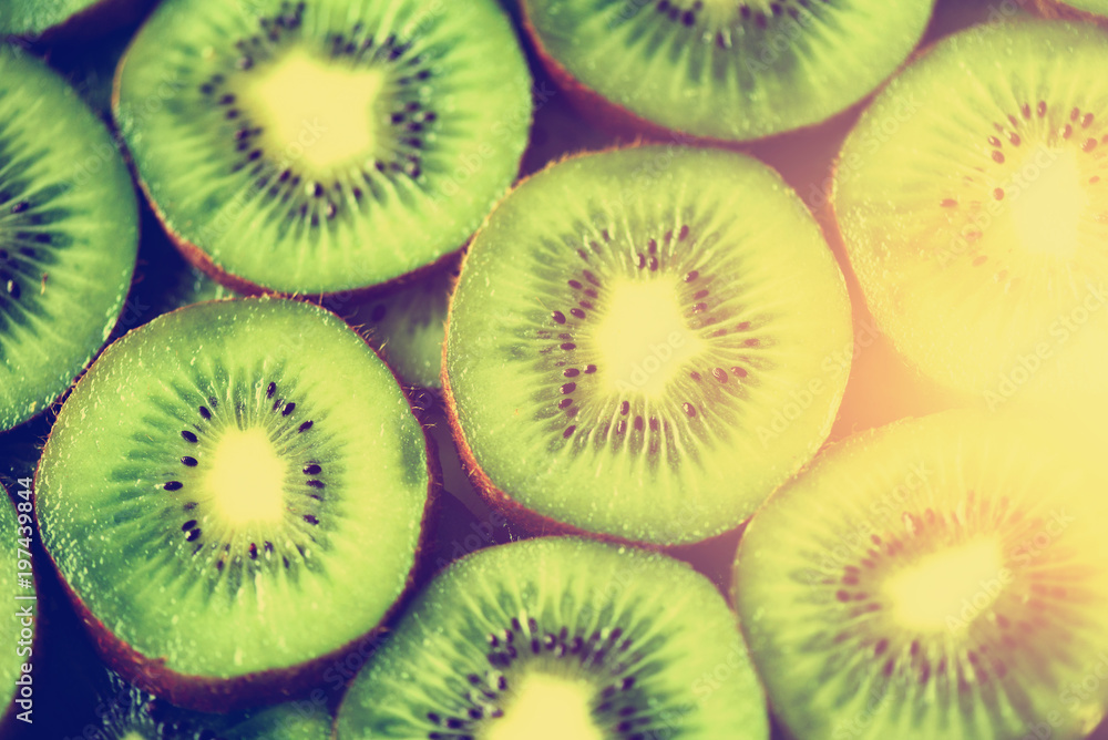Fresh organic kiwi fruit sliced. Food frame with copy space for your text. Banner. Green kiwi circles background Fresh organic kiwi fruit sliced. Food frame with copy space for your text. Banner. Green kiwi circles background