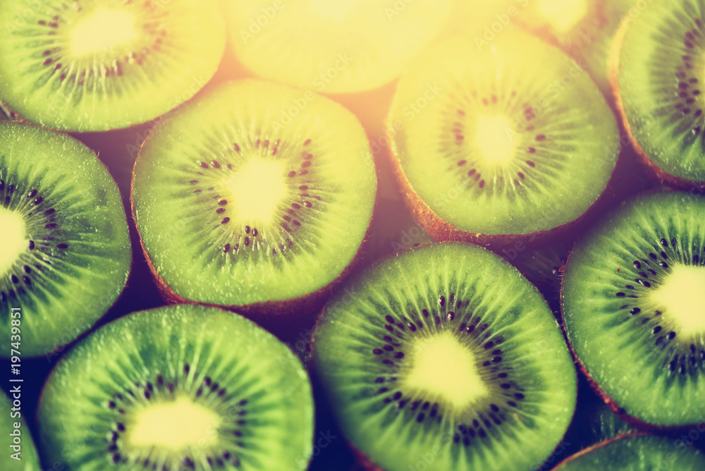 Fresh organic kiwi fruit sliced. Food frame with copy space for your text. Banner. Green kiwi circles background Fresh organic kiwi fruit sliced. Food frame with copy space for your text. Banner. Green kiwi circles background