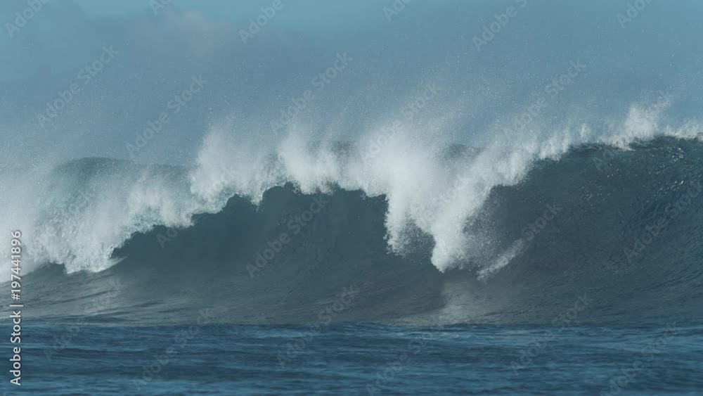 SLOW MOTION Massive emerald ocean swell breaks and sends water droplets flying far away. Glistening crystal clear wave breaks on tranquil summer day near tropical island. Picturesque emerald tube wave SLOW MOTION Massive emerald ocean swell breaks and sends water droplets flying far away. Glistening crystal clear wave breaks on tranquil summer day near tropical island. Picturesque emerald tube wave