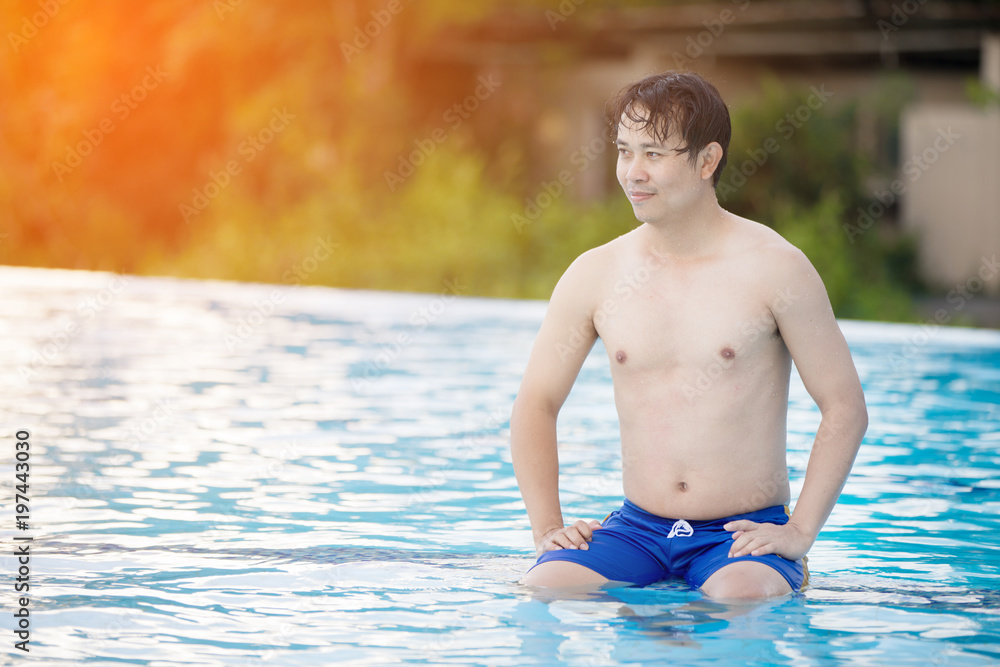 Young man in pool with smile face.