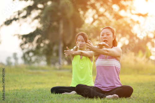 Young asian woman exercising in park.