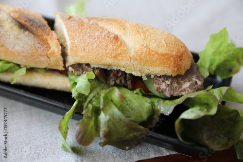 Beef sandwich on wood background