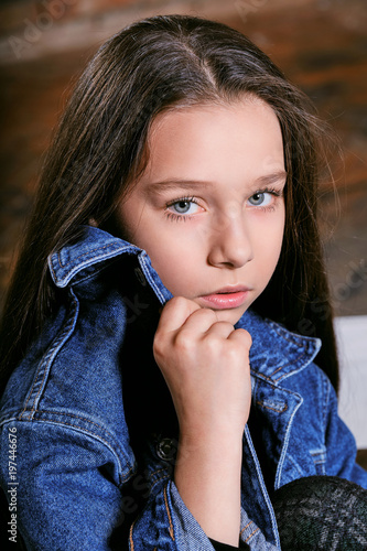 Closeup portrait teenager girl.Perfect face,skin,female teen.Beautiful model child girl holding hand jeans jacket. Model tests adolescent dressed denim jacket,looks sad,confident,expressive,calm eyes.