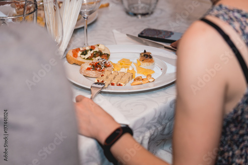 Woman eats Snacks with Pasta  Cheese  Vegetables. Spain tapas recipe food pintxos. Served dish for food and wine tasting