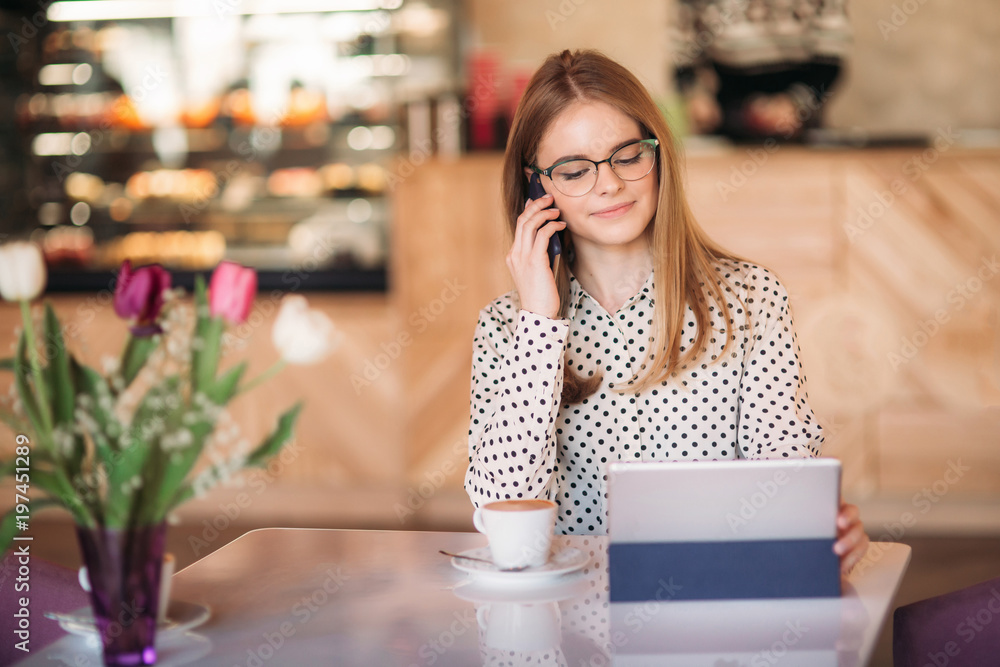 beautiful blond lady use different gadgets and drinking coffee in cafe beautiful blond lady use different gadgets and drinking coffee in cafe
