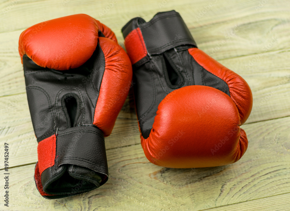 boxing gloves on a wooden background.