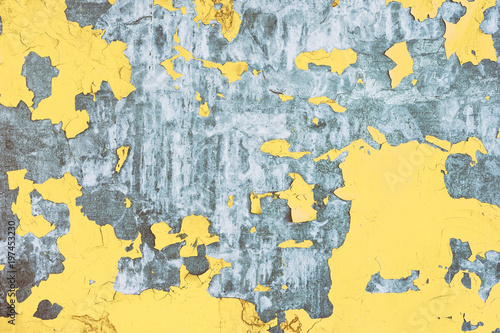 Metal texture with peeling cracked yellow paint