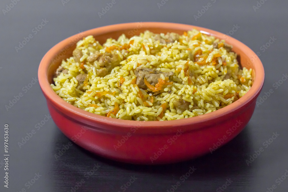 Pilaf with beef, carrots, onions, garlic, pepper and cumin. A traditional dish of Asian cuisine. Pilaf with beef, carrots, onions, garlic, pepper and cumin. A traditional dish of Asian cuisine.