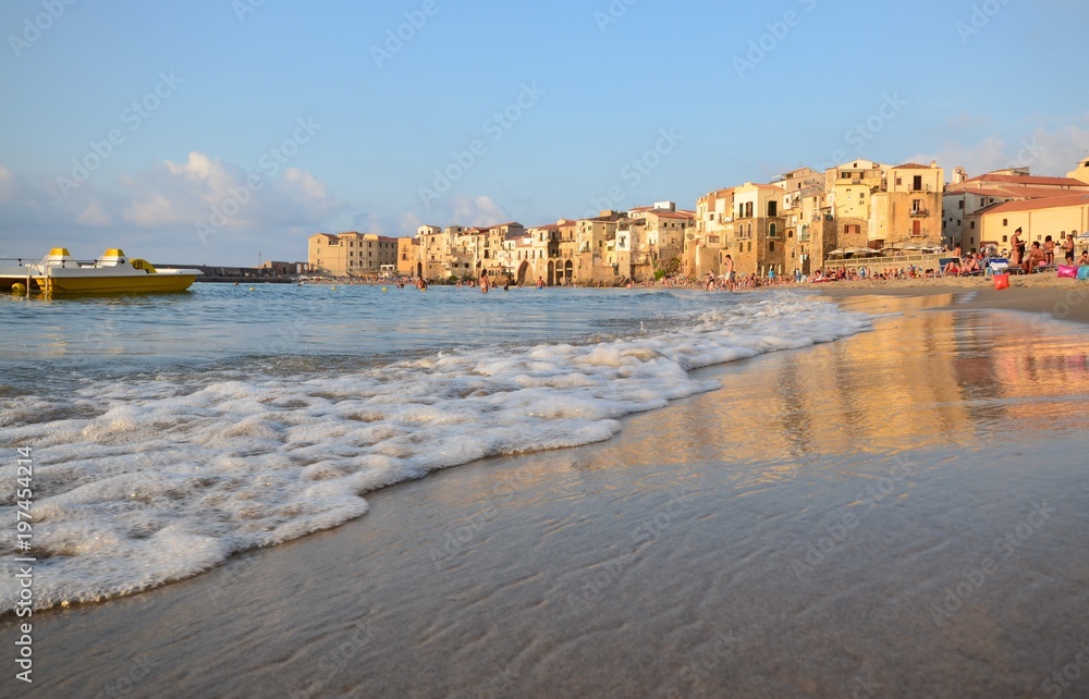 Cefalù, Italy, Sicily August 16 2015 Cefalù beach. It is possible to take a bath admiring the old town overlooking the sea, the fortress of Cefalù overlooking the sea, tourists from all over the world