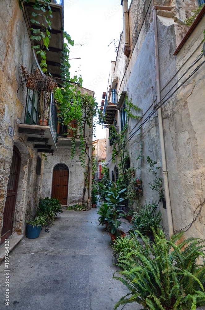 Monreale, Italy, Sicily August 20 2015. The alleys of Monreale, vases in bloom, small balconies, views of the village. Small houses.