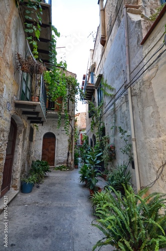 Monreale, Italy, Sicily August 20 2015. The alleys of Monreale, vases in bloom, small balconies, views of the village. Small houses. © Massimo Parisi