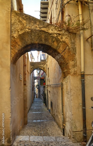 Cefal    Italy  Sicily August 16 2015. The alleys of cefal   that wind at the foot of the fortress behind the cathedral. Steep stairways  picturesque signs. Narrow streets  flower boxes  laundry threads