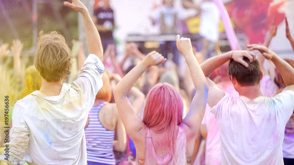 Fototapeta premium Happy friends enjoying positive atmosphere at festival, dancing back view, youth