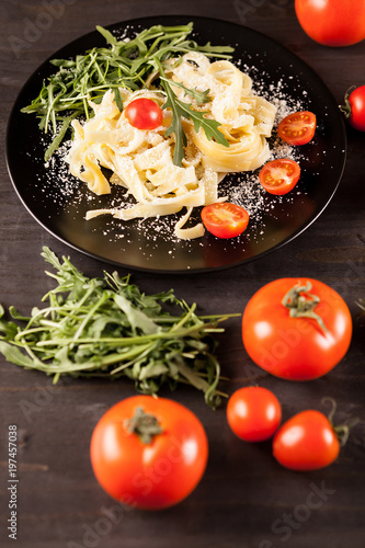Mozzarella cheese with tagliatelle pasta on wooden table