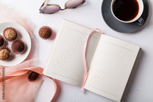 Fotografie Variety of chocolate truffles with a cup of black coffee on white background
