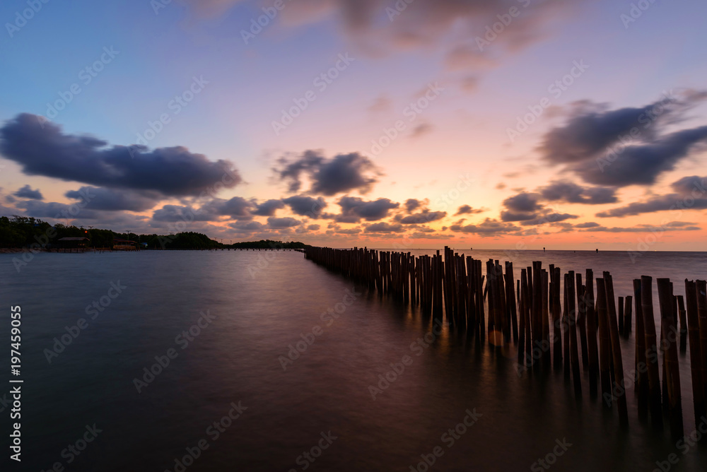 Obraz premium Waves fence attack of the sea in sunrise time