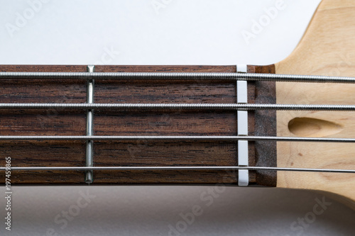 Frets on bass guitar. First fret. Close up. Vintage old retro bass in studio