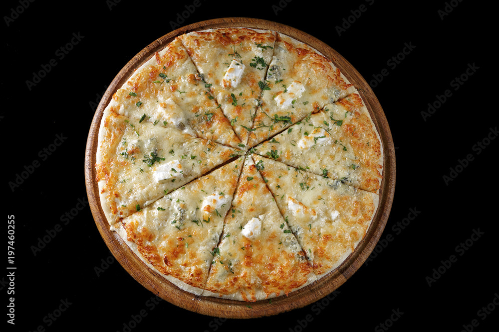 Pizza four cheeses on a wooden board