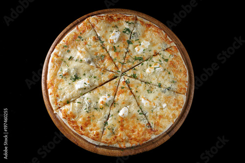 Pizza four cheeses on a wooden board