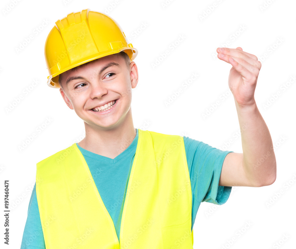 Emotional portrait of handsome teen boy wearing safety jacket and yellow hard hat. Happy child looking at camera, isolated on white background. Funny cute guy - construction Emotional portrait of handsome teen boy wearing safety jacket and yellow hard hat. Happy child looking at camera, isolated on white background. Funny cute guy - construction