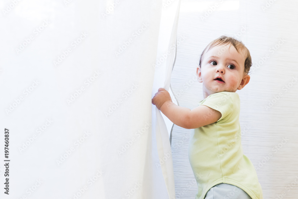baby playing with white curtains baby playing with white curtains