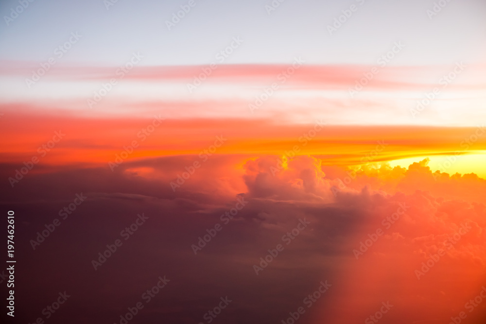 Fototapeta premium Red clouds on the sky. Top view from the plane