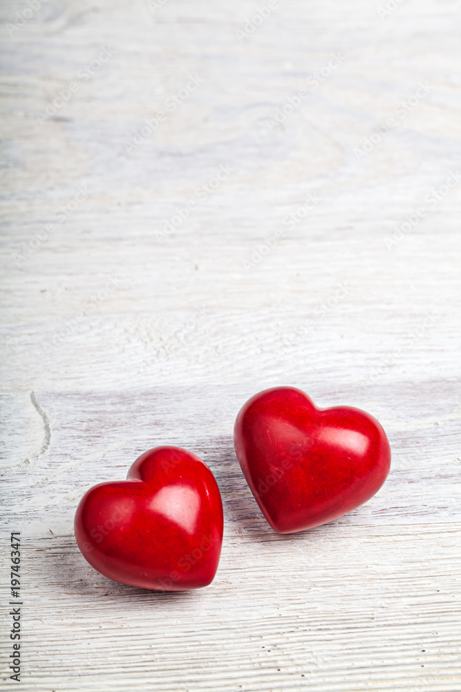 Fototapeta premium Two red hears valentine on light background