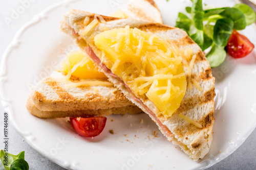 Hot fresh hawaii toast sandwich with ham, pineapple, tomato and cheese. Healthy summer food concept.