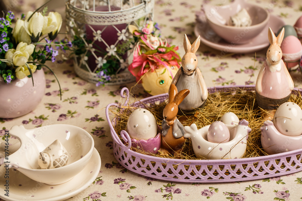 Easter breakfast table with tea,eggs in egg cups, spring flowers in vase and Easter decor