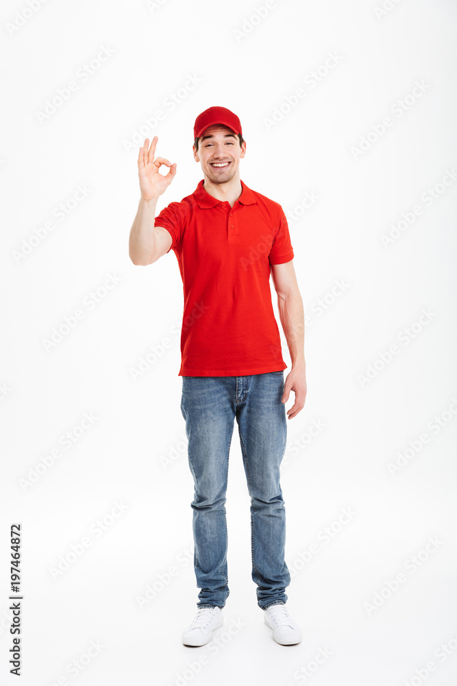 Smiling young delivery man with okay gesture Smiling young delivery man with okay gesture