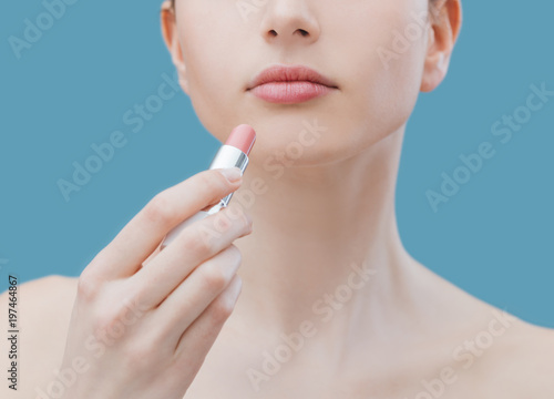 Woman applying lipstick