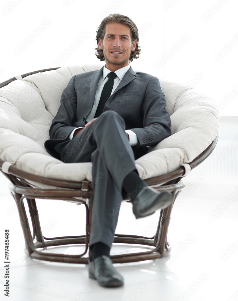 confident businessman sitting in a large comfortable chair.
