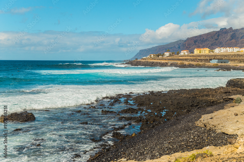 The blue waters of the Atlantic Ocean flowing into rocky cove off the coast of Tenerife.rocky coast of Canary Islands.