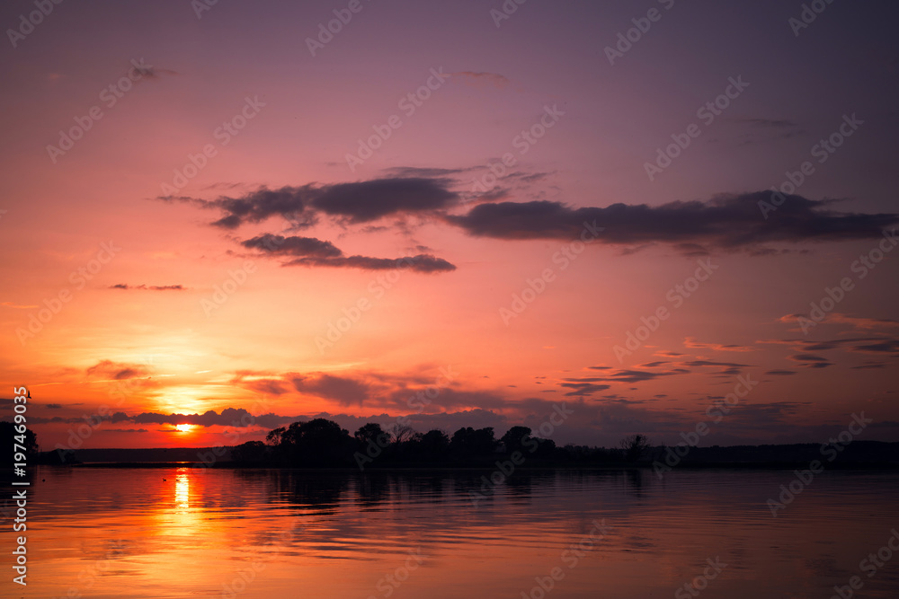 Beautiful blazing sunset at lake