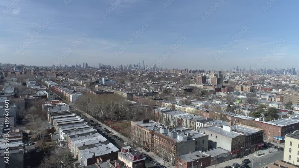Drone shot, high and expanded view of Brooklyn, with the beautiful Newyork city view in the background, birds flying across the daylight sky Drone shot, high and expanded view of Brooklyn, with the beautiful Newyork city view in the background, birds flying across the daylight sky
