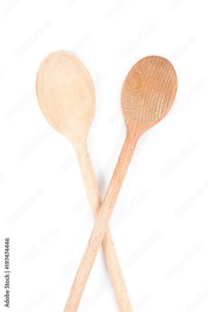 Two long wooden stirring spoons isolated on white background Two long wooden stirring spoons isolated on white background