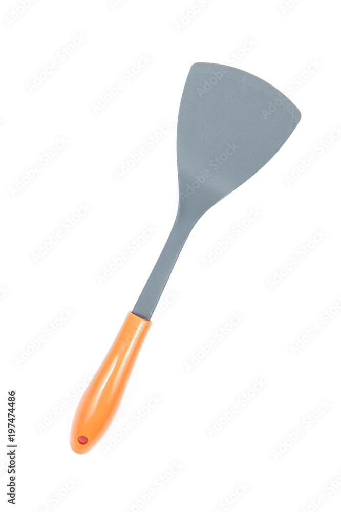 Grey plastic kitchen spatula with orange handle isolated on white background, surface. Kitchen accessory. Grey plastic kitchen spatula with orange handle isolated on white background, surface. Kitchen accessory.