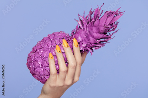 Nails Manicure. Hand With Stylish Nails Holding Purple Pineapple