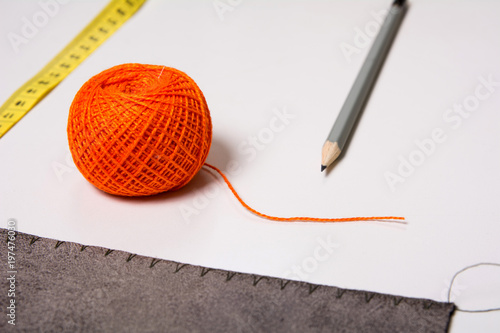 Background for tailor orange thread ribbon and pencil photo