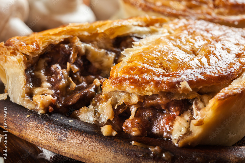 Fresh beef stew pie on a cutting board Fresh beef stew pie on a cutting board