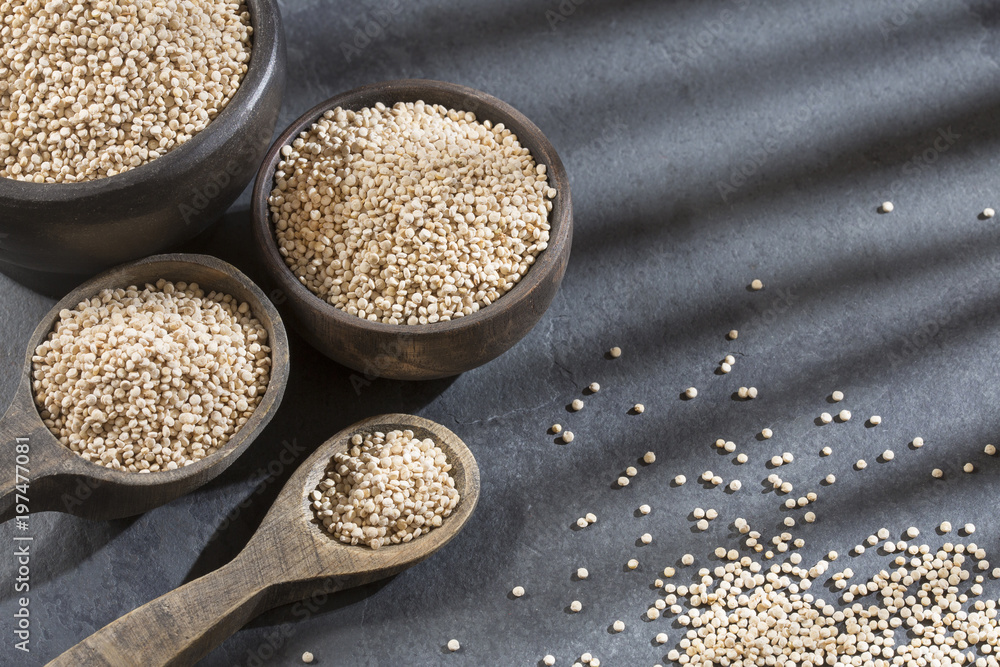 Organic quinoa seeds in the bowl and spoon Organic quinoa seeds in the bowl and spoon