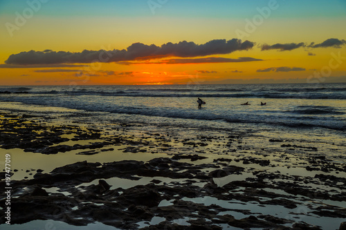 Sunset Background Ocean. Tropical Sunlight and Summer Sunset View. Colorful Background Sunset. Blue Waves near sea Resort. Sea sunset Background. Colorful Beach with Surfers on the Horizon. Landscape