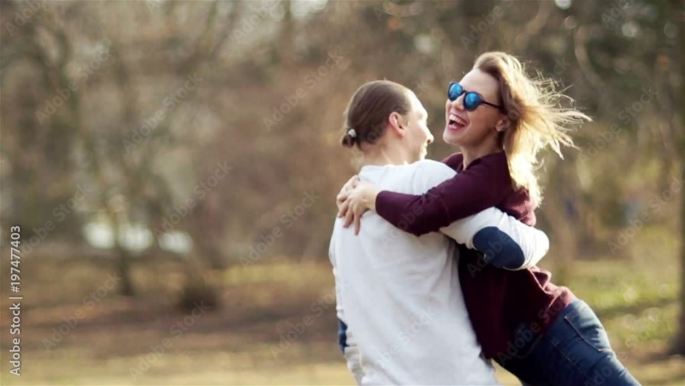 Middle-aged woman and man hugging in a spring park. Meeting after a long separation Middle-aged woman and man hugging in a spring park. Meeting after a long separation