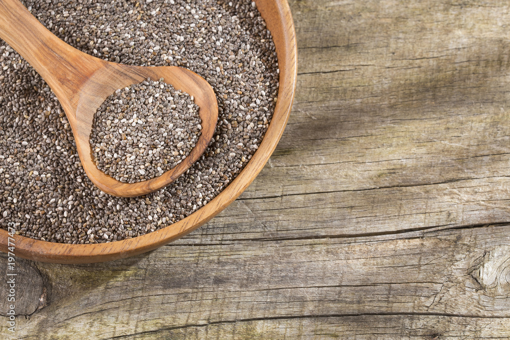 Organic chia seeds in the bowl and spoon Organic chia seeds in the bowl and spoon