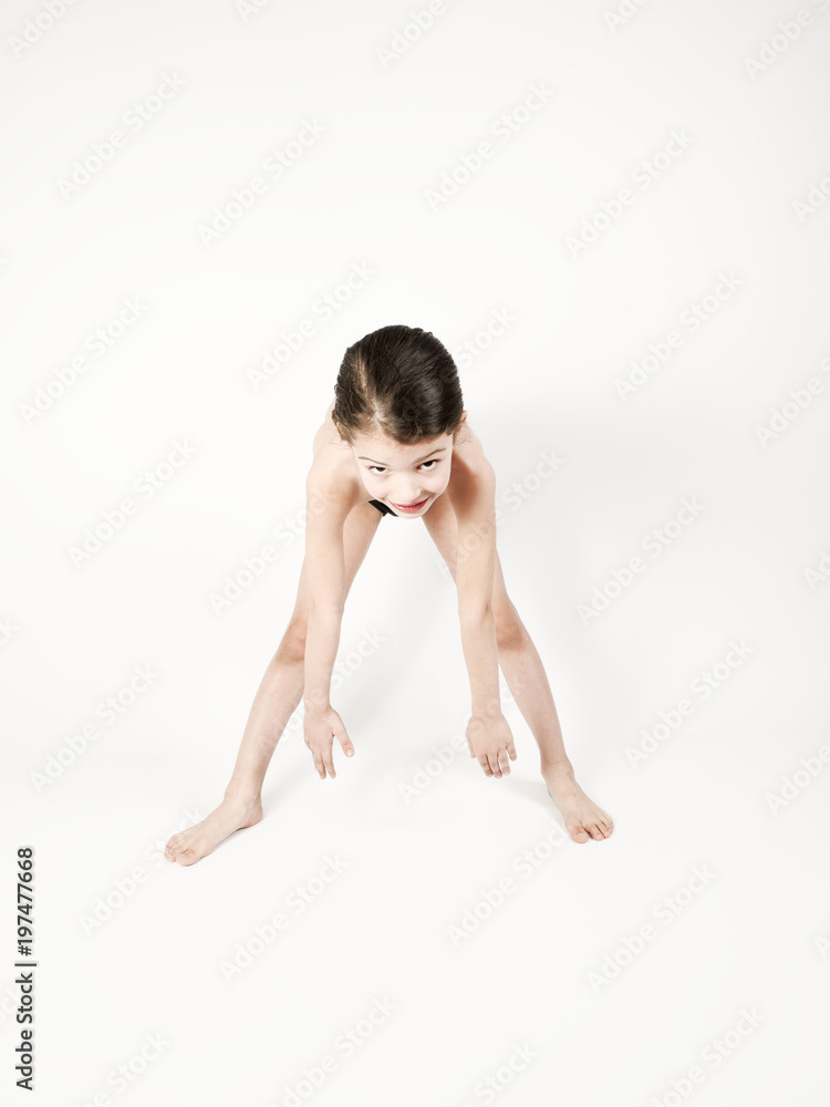Nice barefoot boy in sport outfit stretching back muscles, looking relaxed Nice barefoot boy in sport outfit stretching back muscles, looking relaxed