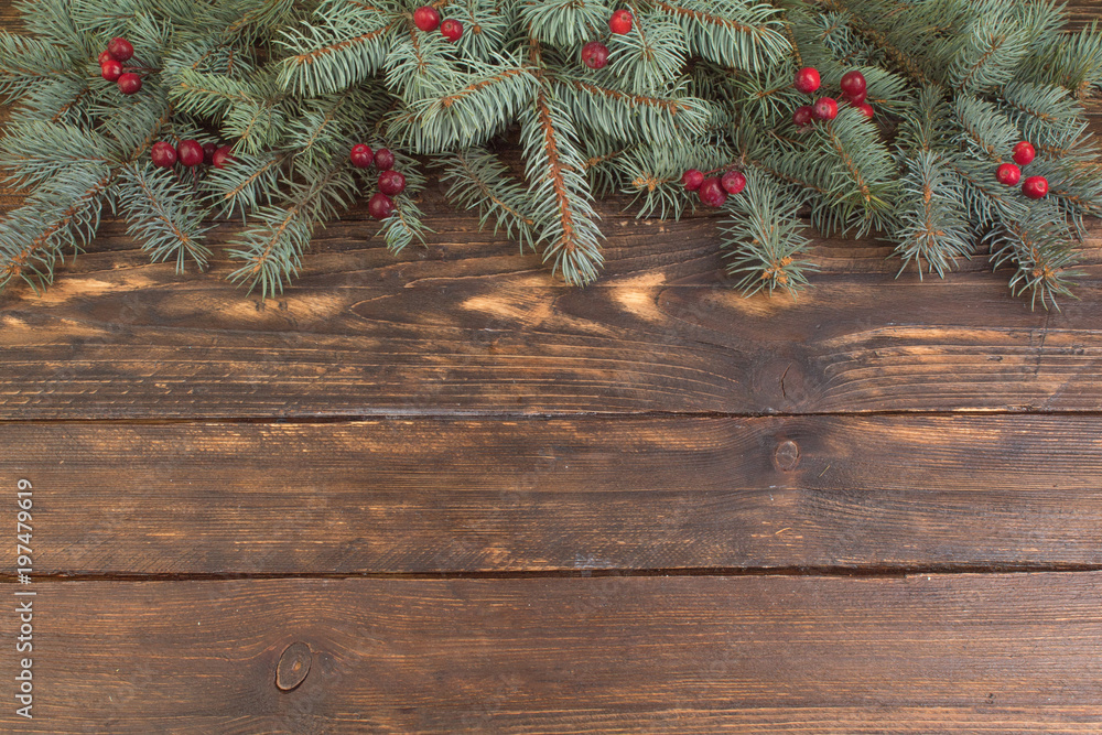 Christmas composition of fir branches and berries of viburnum on a wooden background . Top view with copy space. Christmas composition of fir branches and berries of viburnum on a wooden background . Top view with copy space.