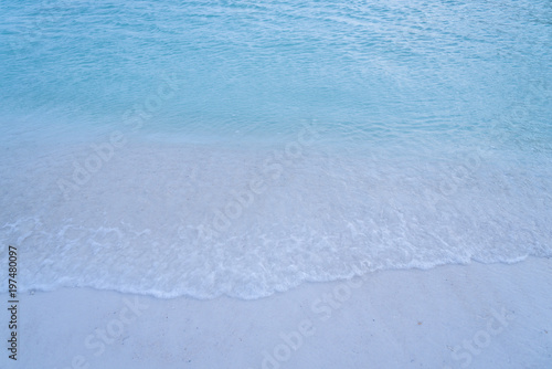 closed up clear and blue wave of the sea on white beautiful island beach